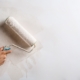 Close up photo of hand painting new plaster