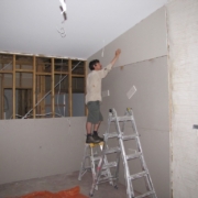 Workman using plasterboard