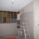 Workman using plasterboard