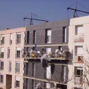 Team applying external wall insulation to a building