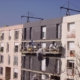 Team applying external wall insulation to a building