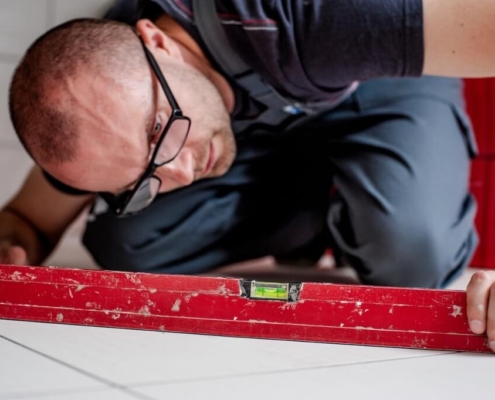 Tradesperson checking a floor with a spirit level