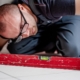 Tradesperson checking a floor with a spirit level