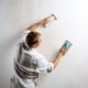 Plasterer sanding a wall