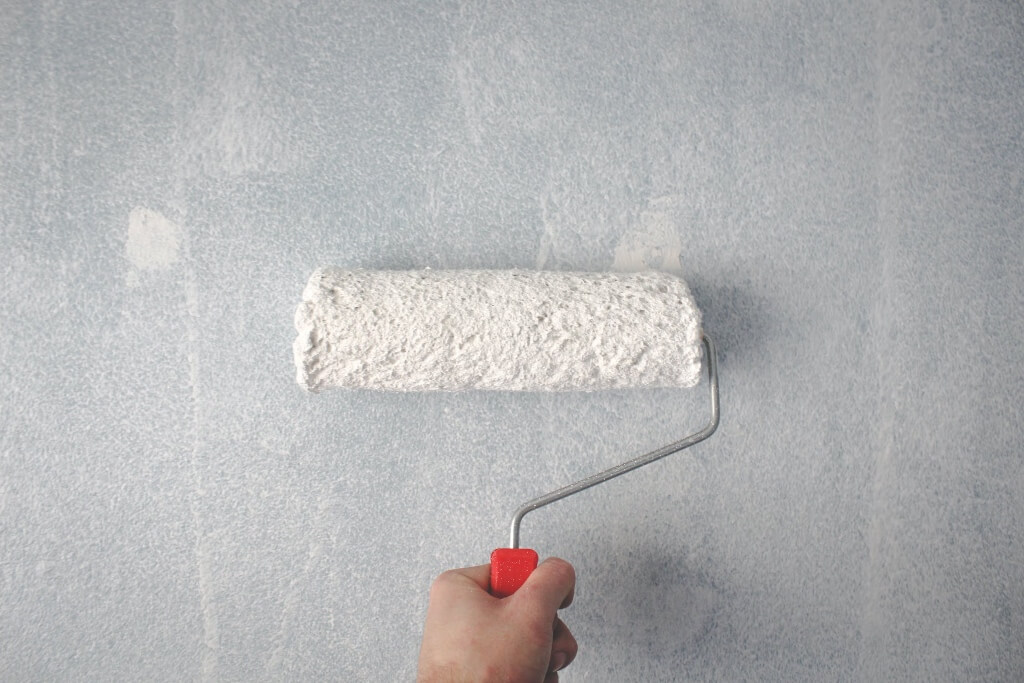 Pexels Licence - Malte Luk Hand holding a paint roller on a wall