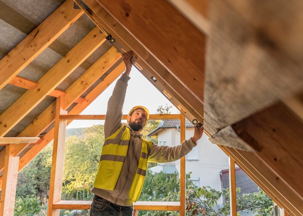 Image by Freepik Carpenter working on roof timber